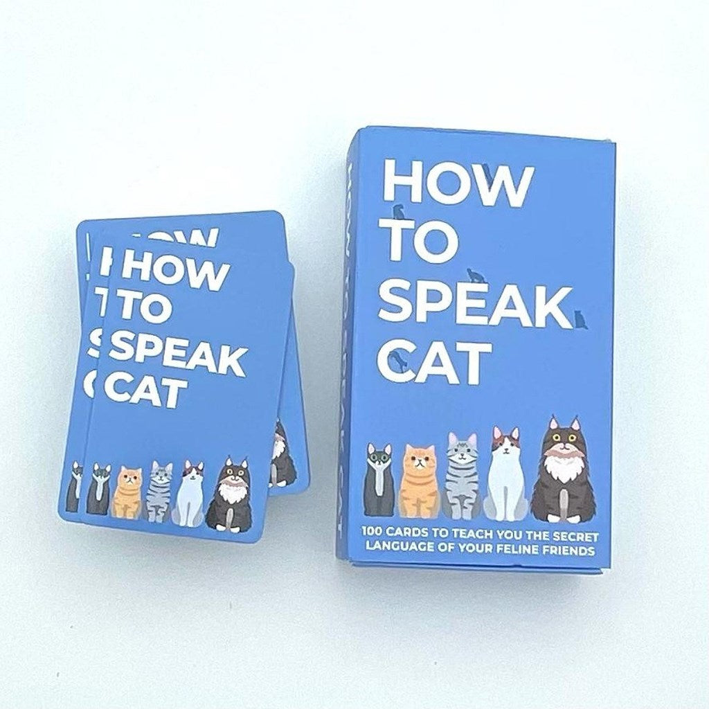 A blue card deck and matching box labeled "HOW TO SPEAK CAT" with illustrated cats along the bottom, photographed on a plain white background.