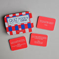 Quiz in a Tin game with red question cards on a gray background