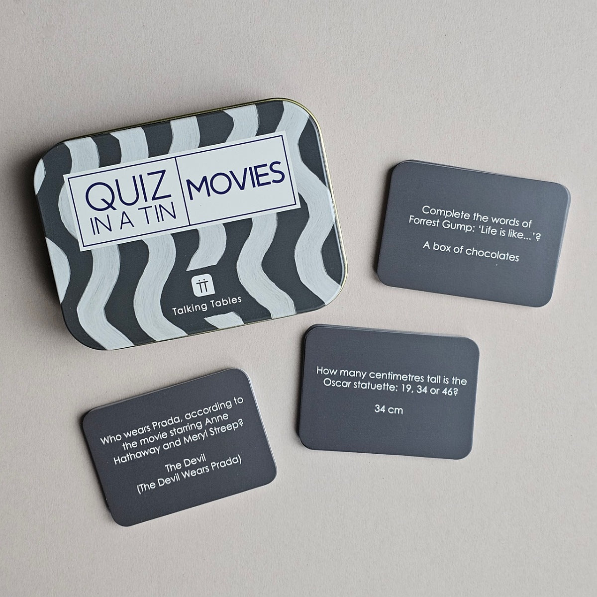 Quiz in a Tin with movie-themed question cards on a grey background