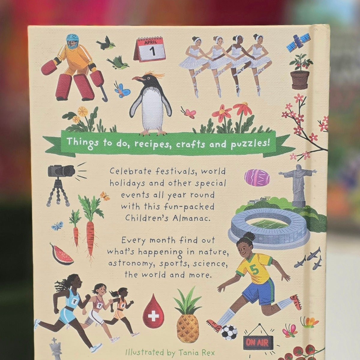 Children's Almanac book cover featuring colorful illustrations of children, animals, sports, and seasonal elements on a cream background, with the title 'Things to do, recipes, crafts and puzzles!' and author credit 'Illustrated by Tania Rex'.