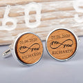 A pair of round silver cufflinks with engraved light brown wood faces, featuring the wording '20.06.2020' infinity shaped wording 'Mr and Mrs' and the name 'Richardson'