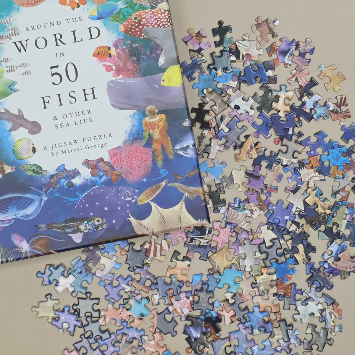 Jigsaw puzzle with 'Around the World in 50 Fish' book