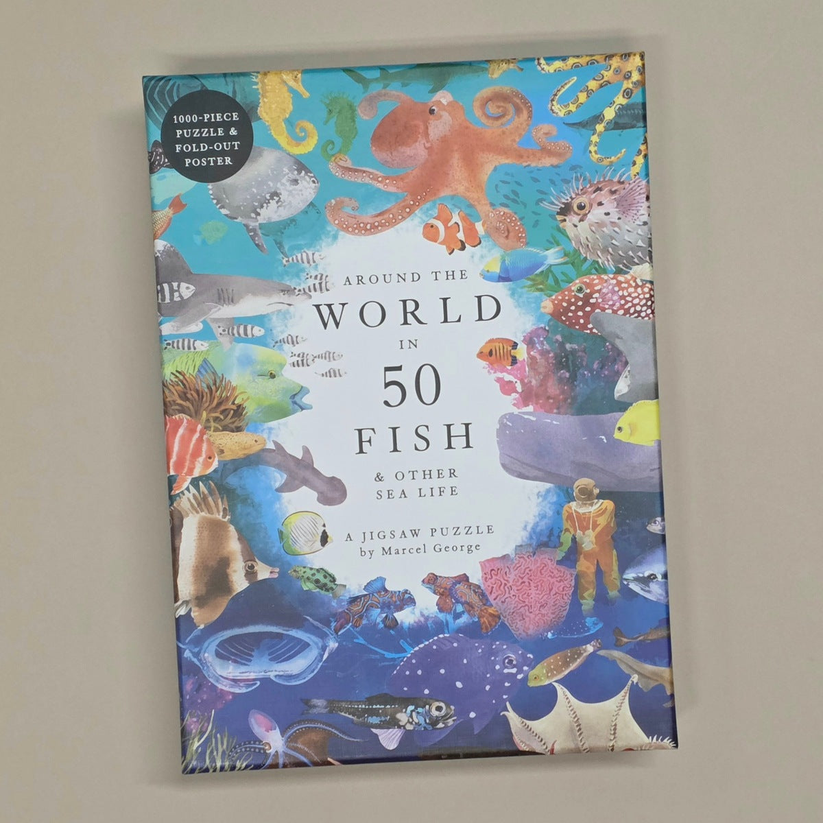 Jigsaw puzzle box with underwater theme and various sea creatures on a beige wall.