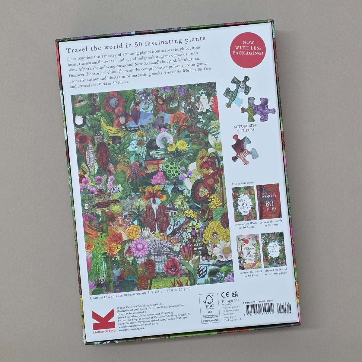Jigsaw puzzle box with colorful plant design on a grey background