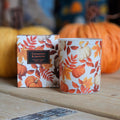 Autumn themed candle and box with the words 'cinnamon and jasmine scented candle', surrounded by pumpkins.