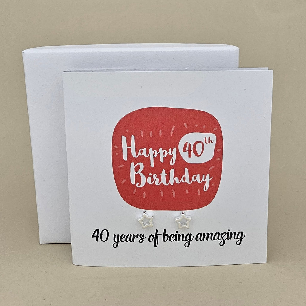 A pair of silver open star earrings displayed on a white card with a red rounded square and the text 'Happy 40th Birthday' and ’40 years of being amazing,' 
