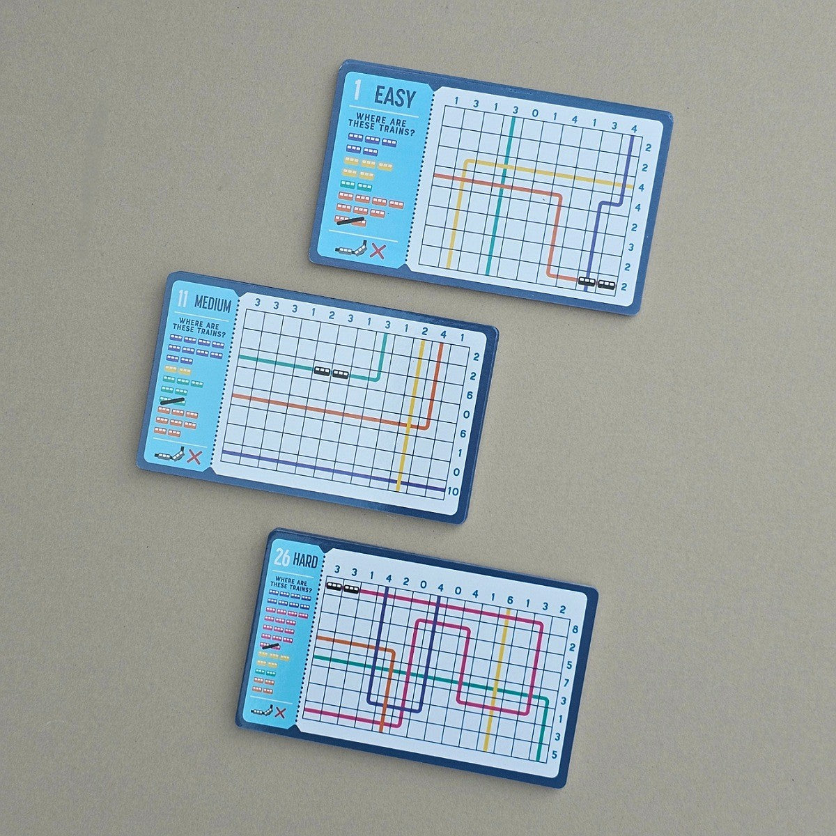 Three grid-based puzzles of varying difficulty levels on a beige background