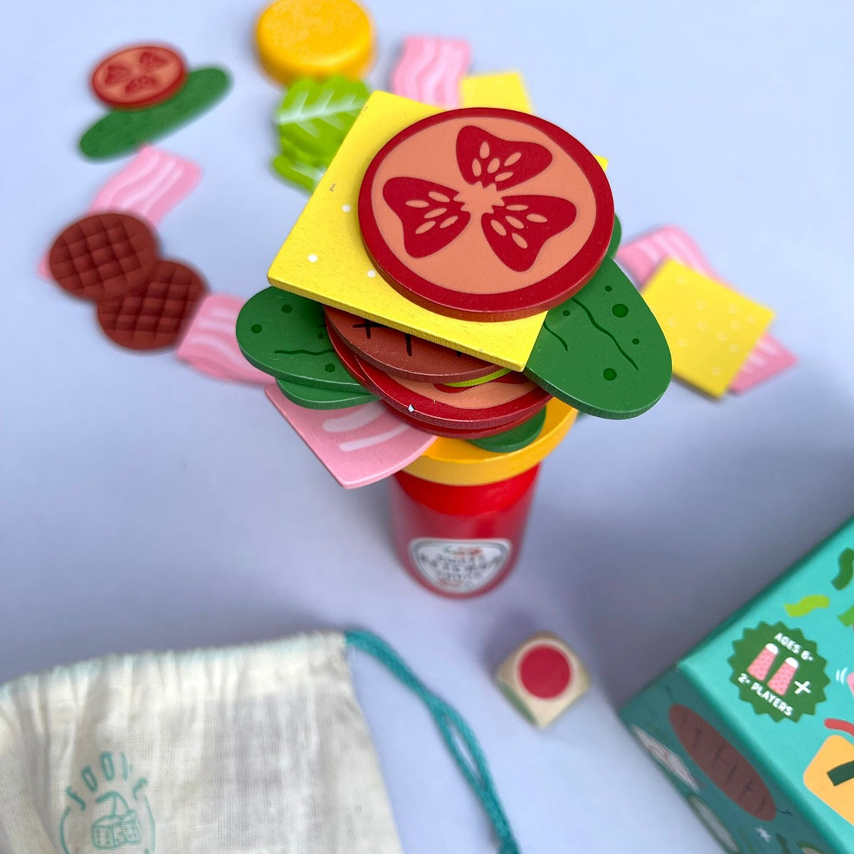 Colorful toy set with geometric shapes resembling vegetables on a blue  background