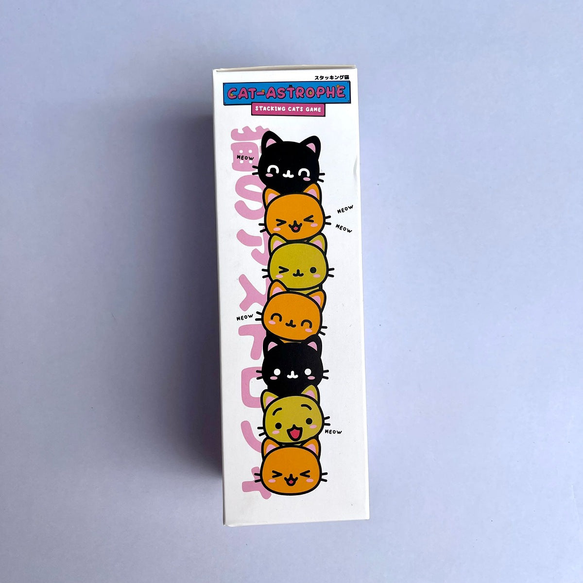 Box with colorful cat illustrations on a light blue background