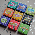 Collection of mini trivia game boxes on a gray background with star decorations.