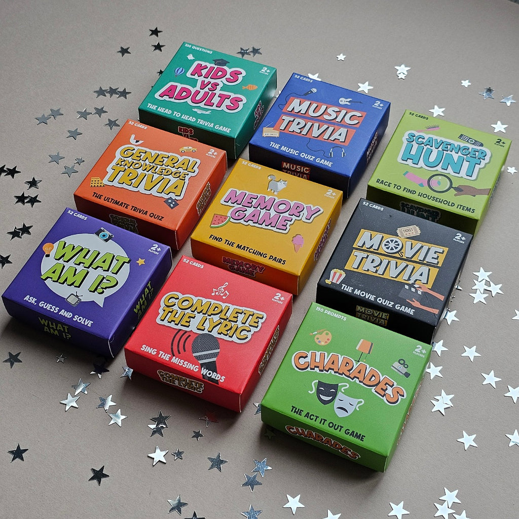 Collection of trivia game boxes on a gray surface with star-shaped confetti.