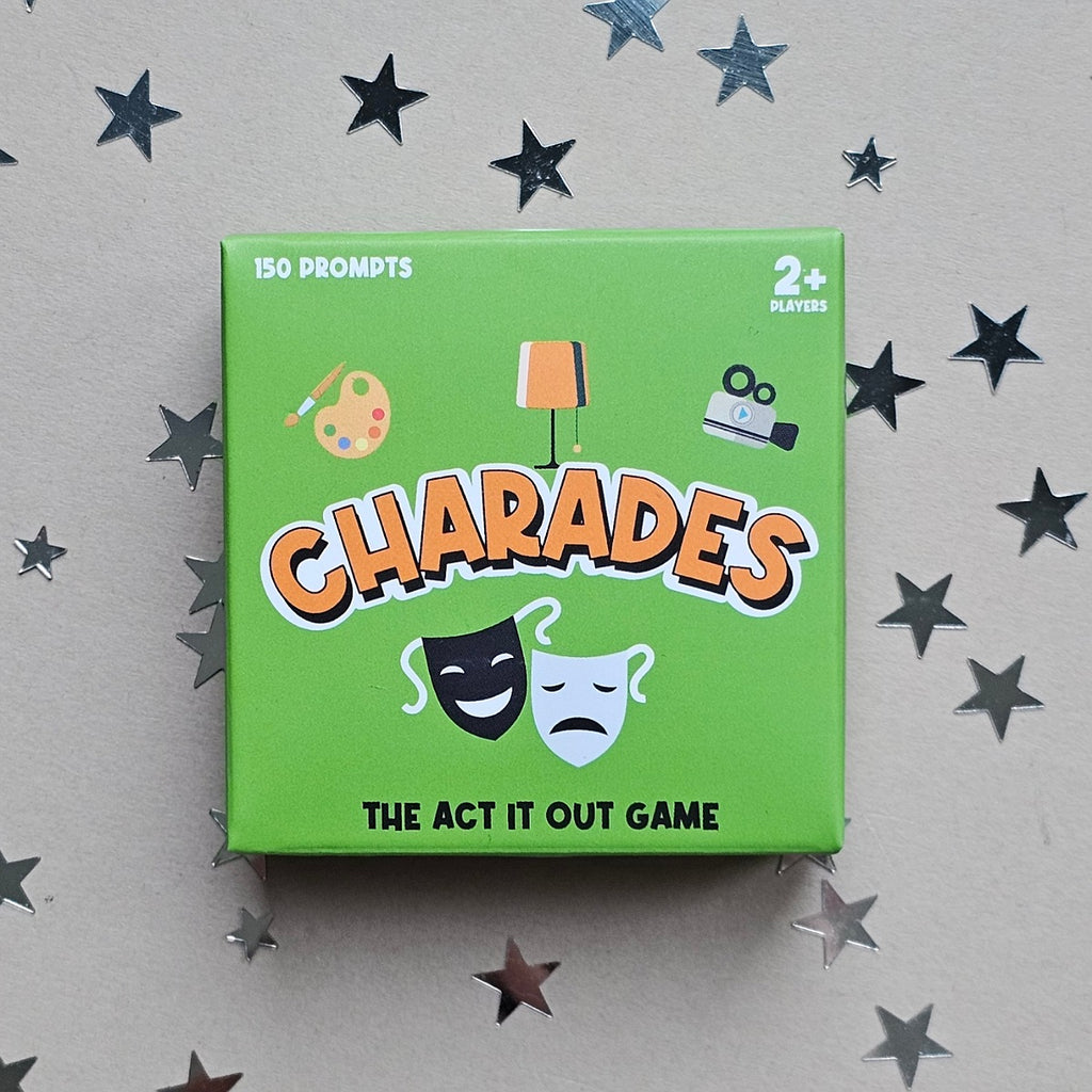 Green box of 'Charades' game with star decorations on a gray background