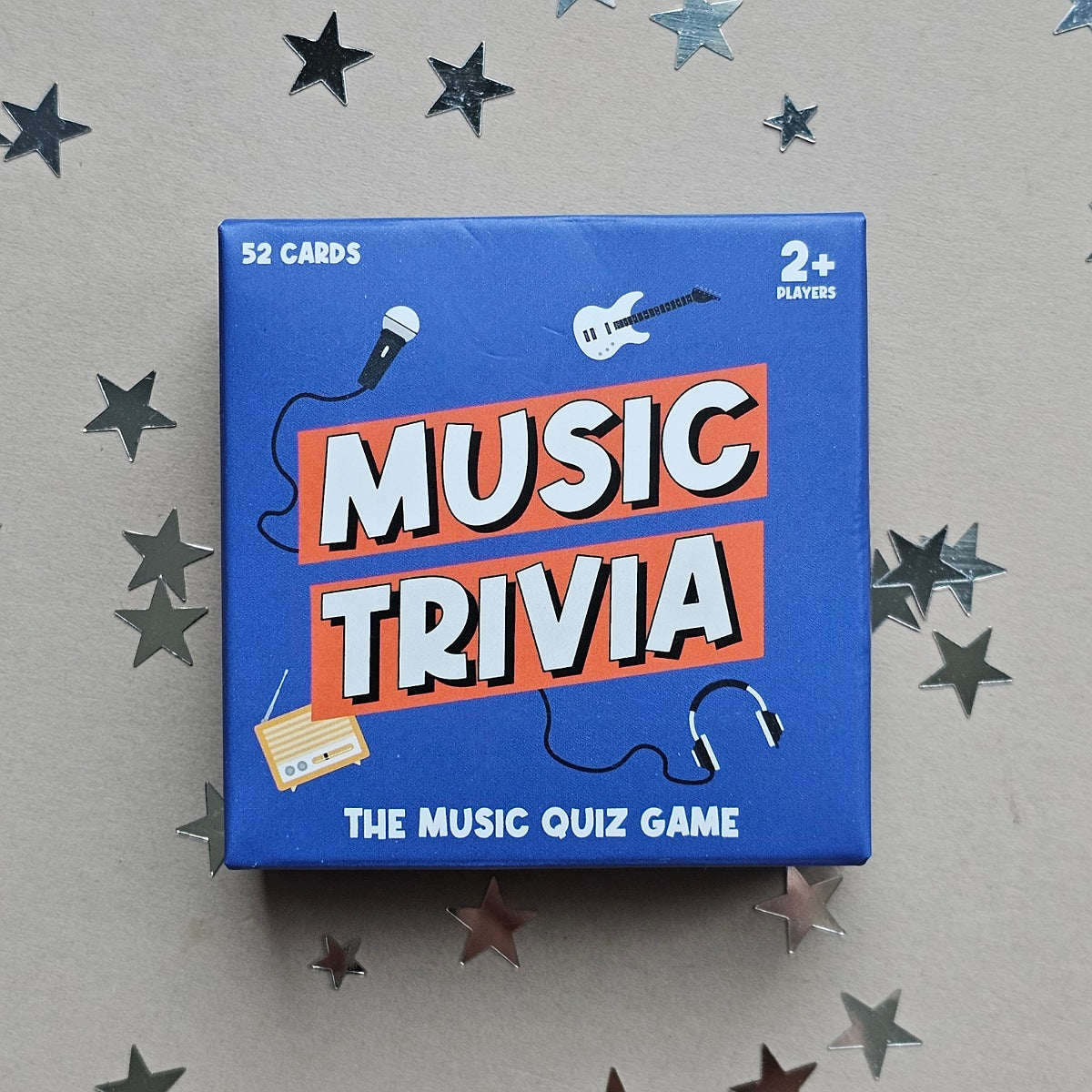 Music trivia game box with star decorations on a gray background
