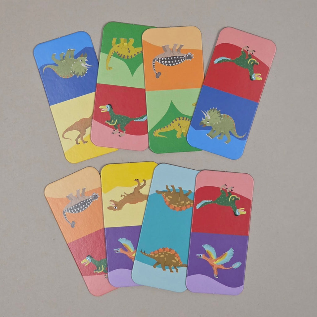 Set of colorful cards with dinosaur illustrations on a grey background
