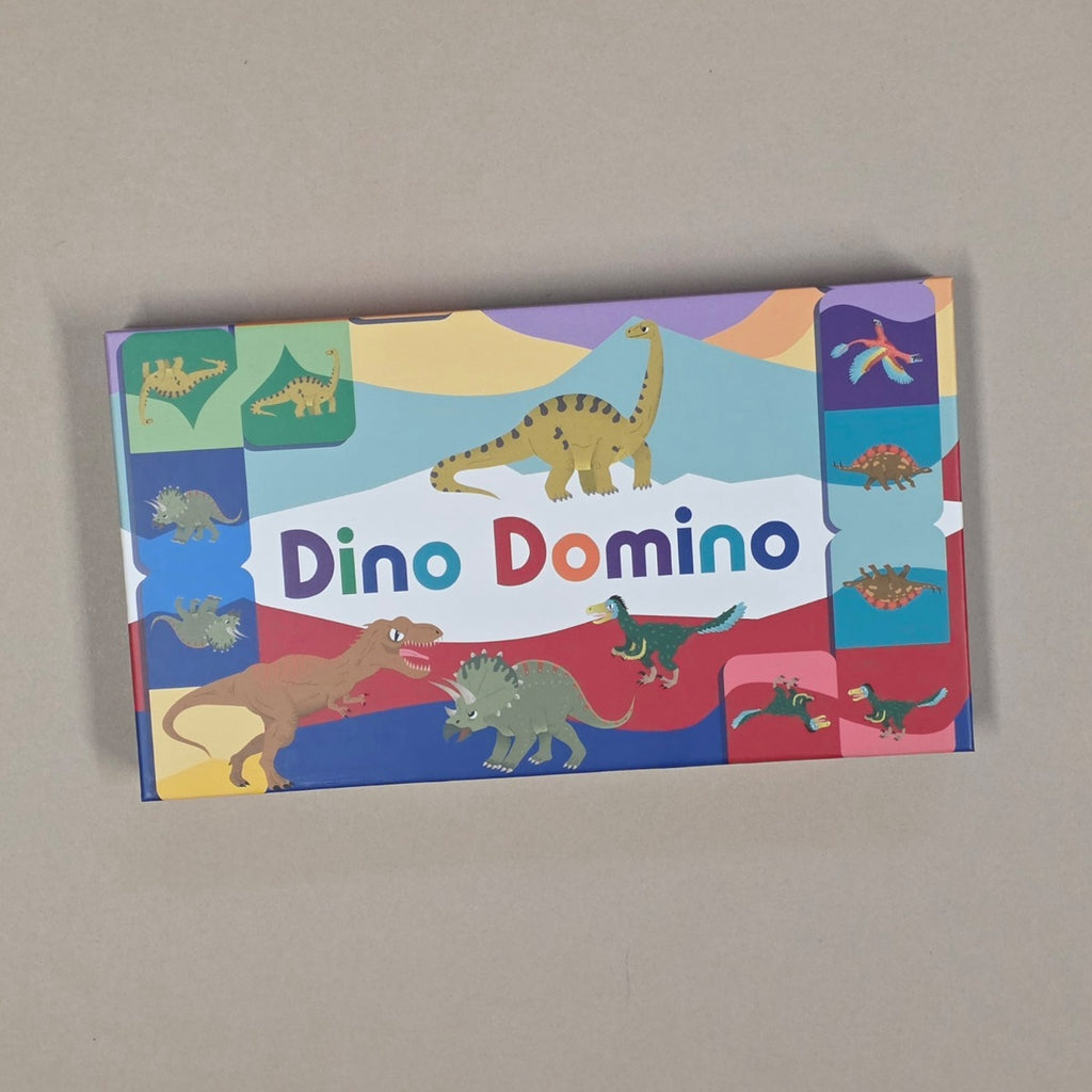 Dino Domino toy box with colorful dinosaur illustrations on a beige background