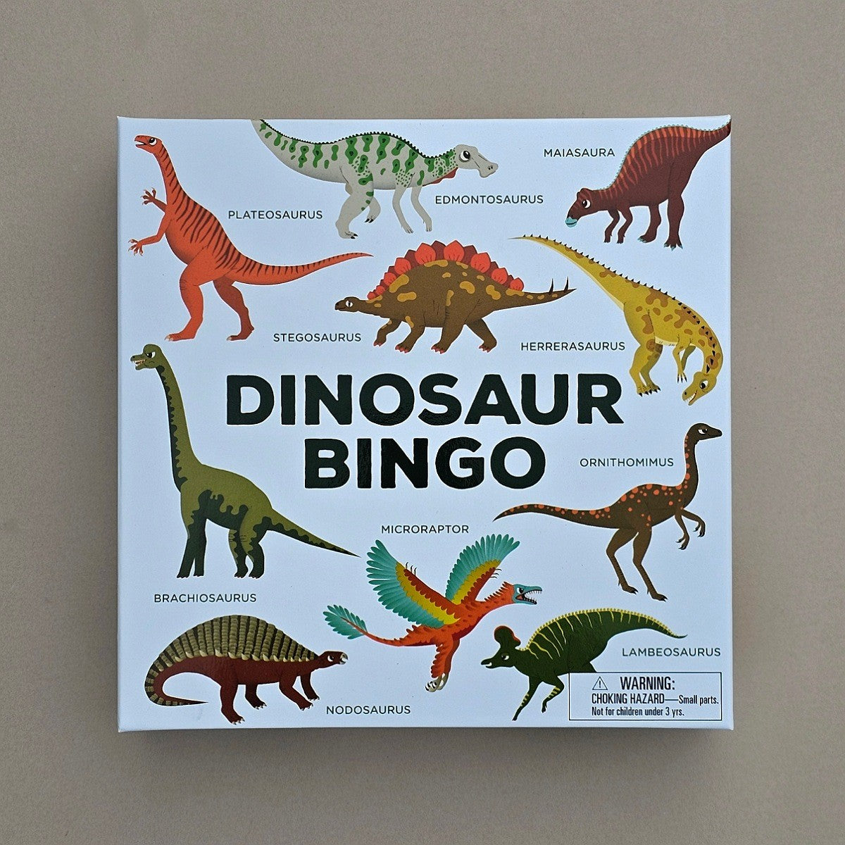 Dinosaur Bingo game box with illustrations of various dinosaurs on a beige background