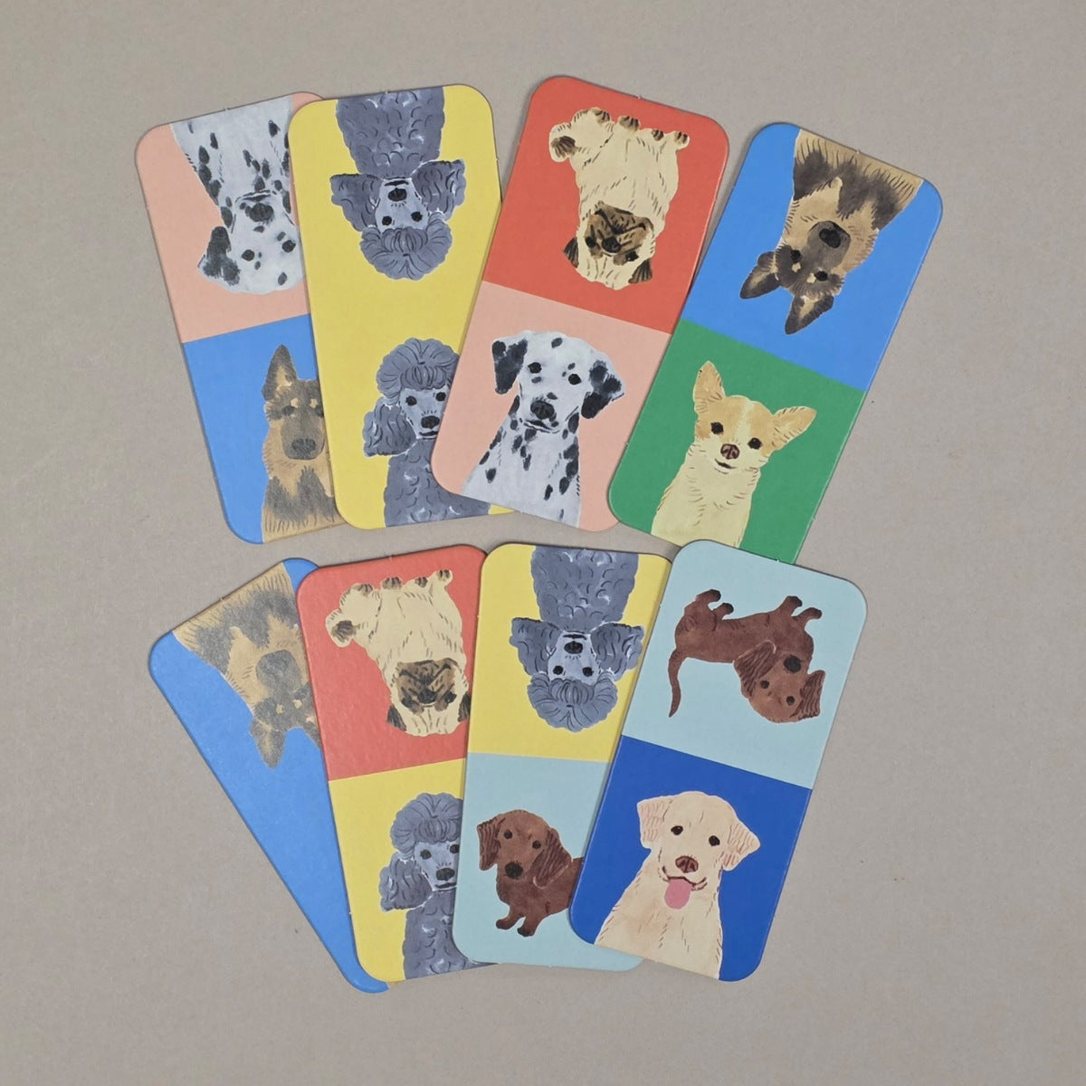 Set of playing cards with dog illustrations on a beige background