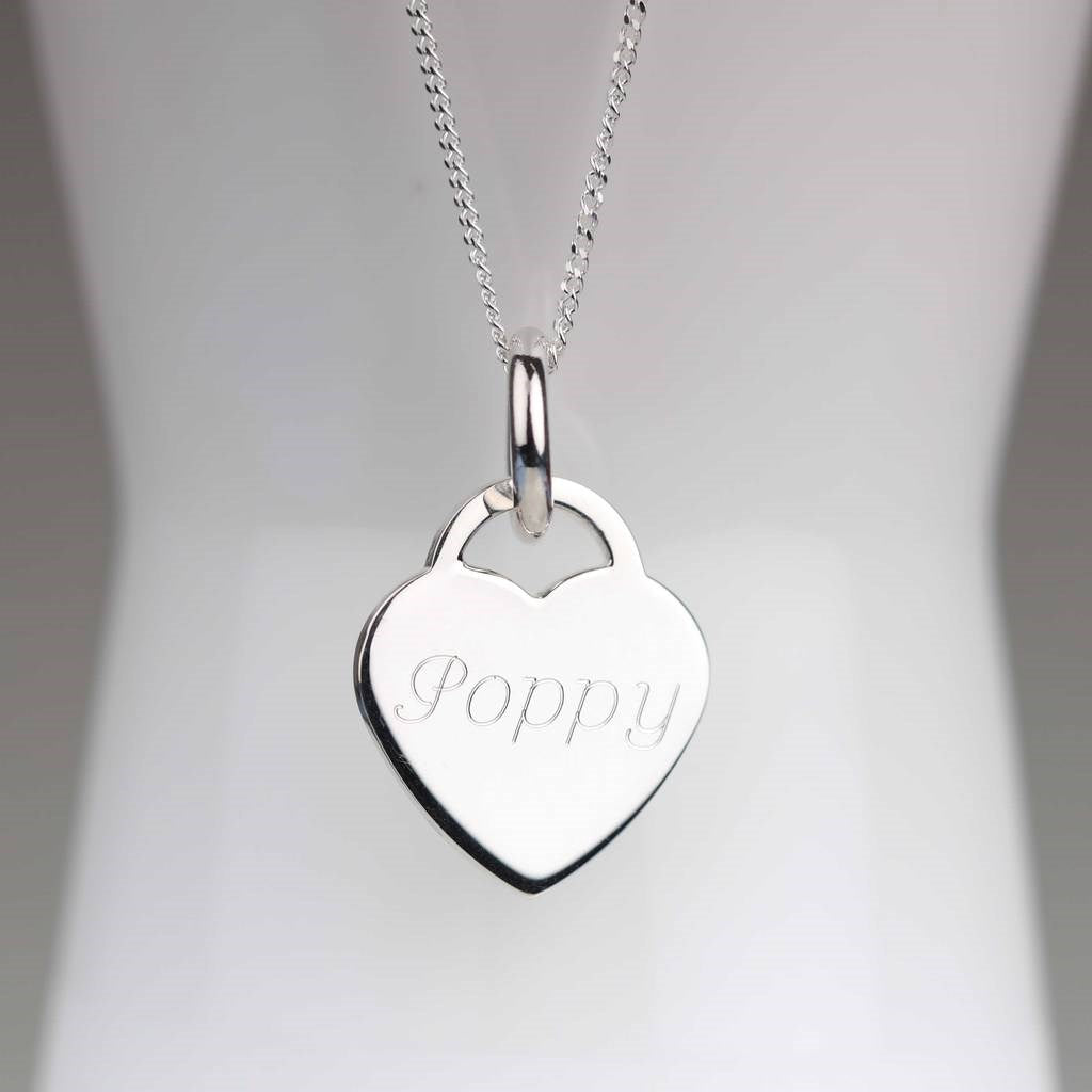 A silver heart-shaped pendant necklace engraved with the name 'Poppy', displayed on a white mannequin bust against a soft gray background.