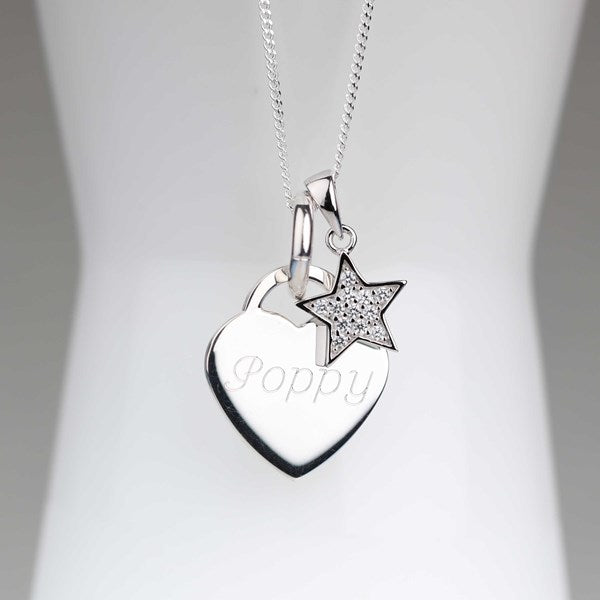 A silver heart and star pendant necklace displayed on a white mannequin bust. The heart-shaped pendant is engraved with the name 'Poppy' and hangs from a silver star charm with a pavé-set crystal border.