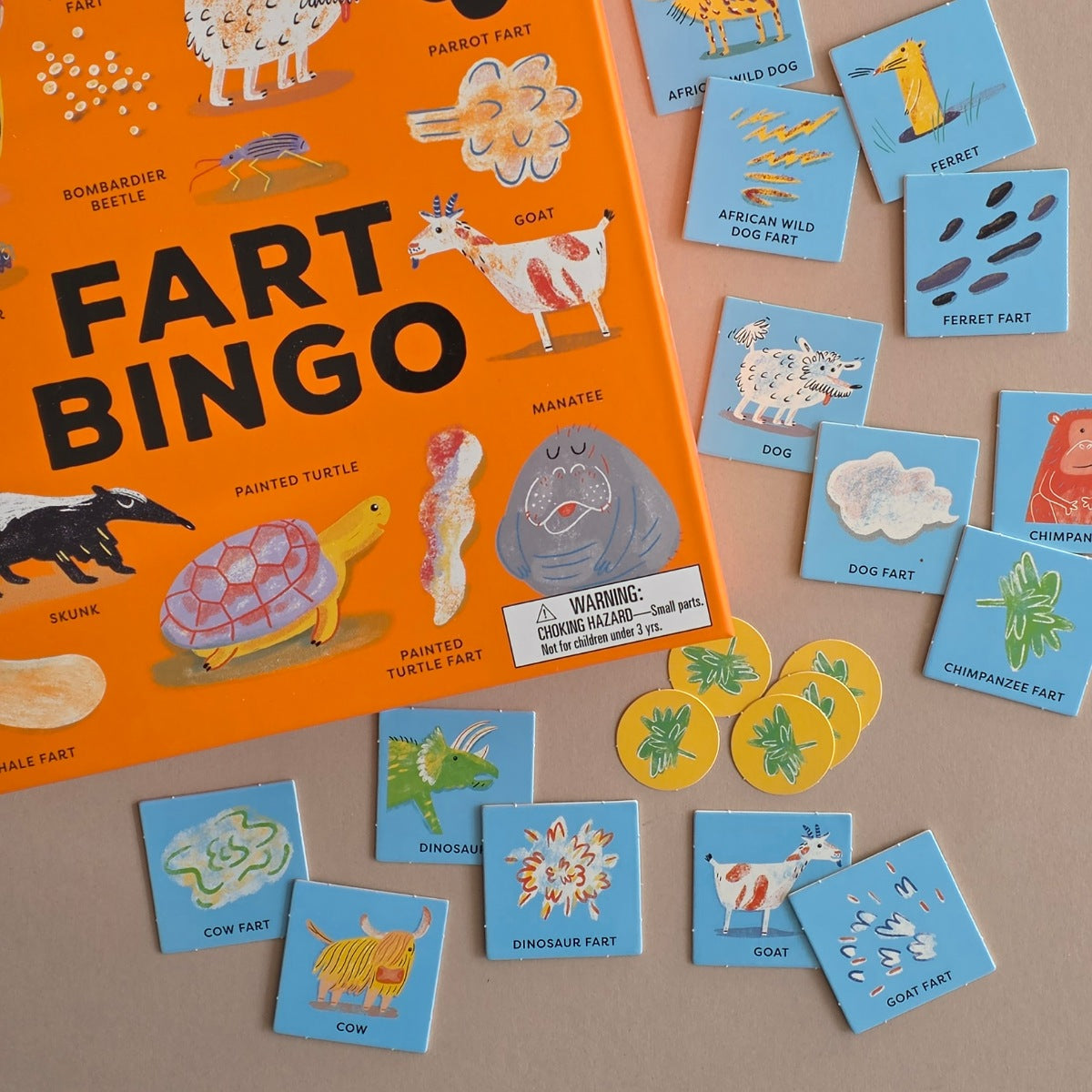 Fart Bingo game set with cards and markers on a brown background