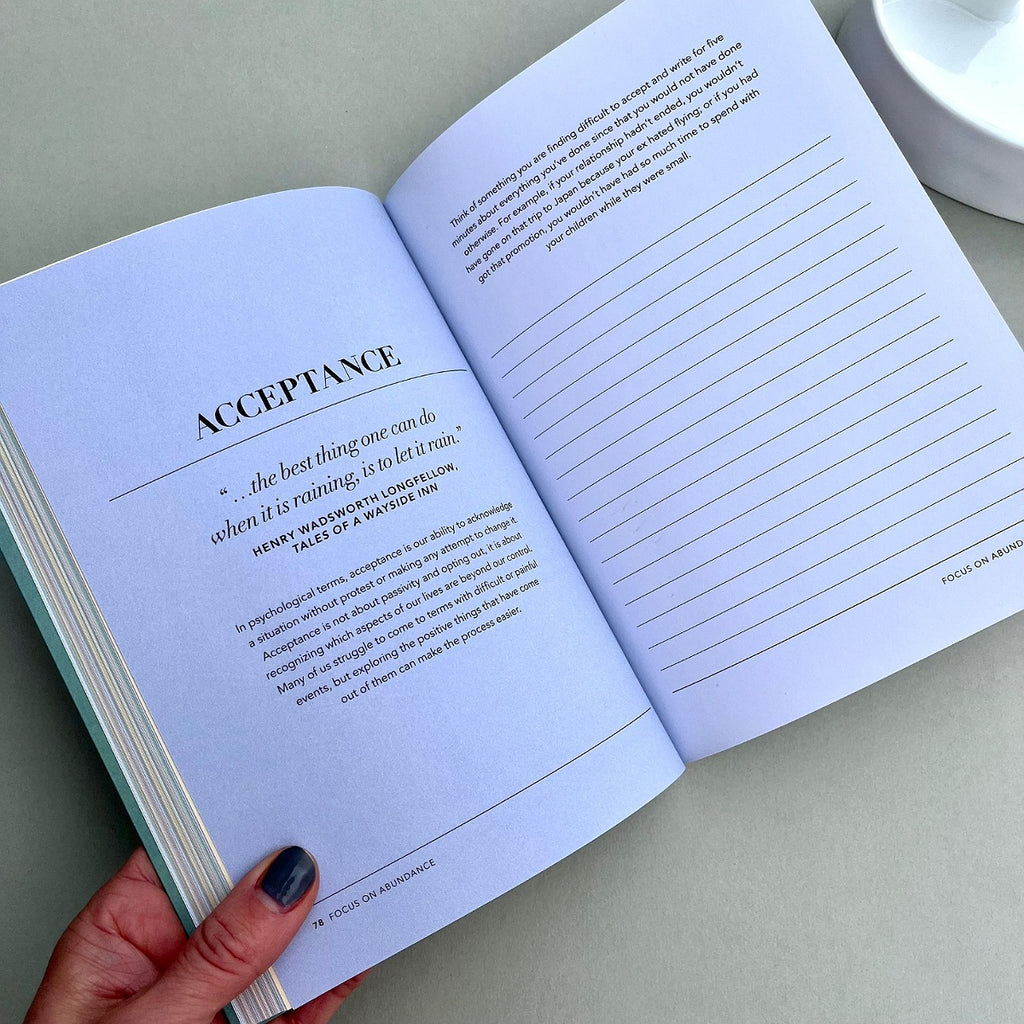 Open book with text and lined pages on a light surface