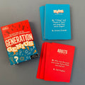 Generation Genius card game set on a grey surface, showing the red and blue box, a stack of blue question cards for kids, and several red adult question cards.
