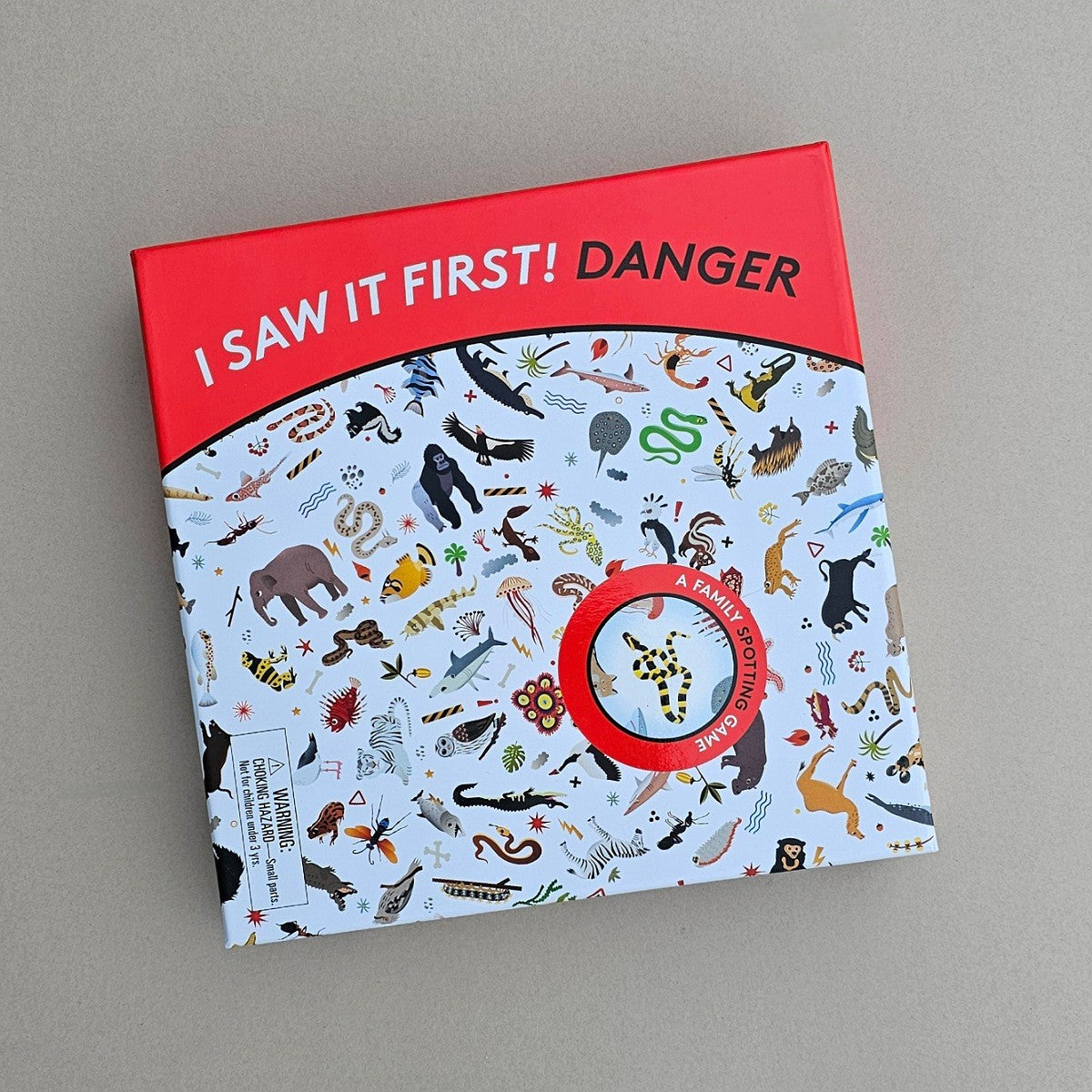 Boxed childrens game  'I Saw It First! Danger' text and animal illustrations on a grey background