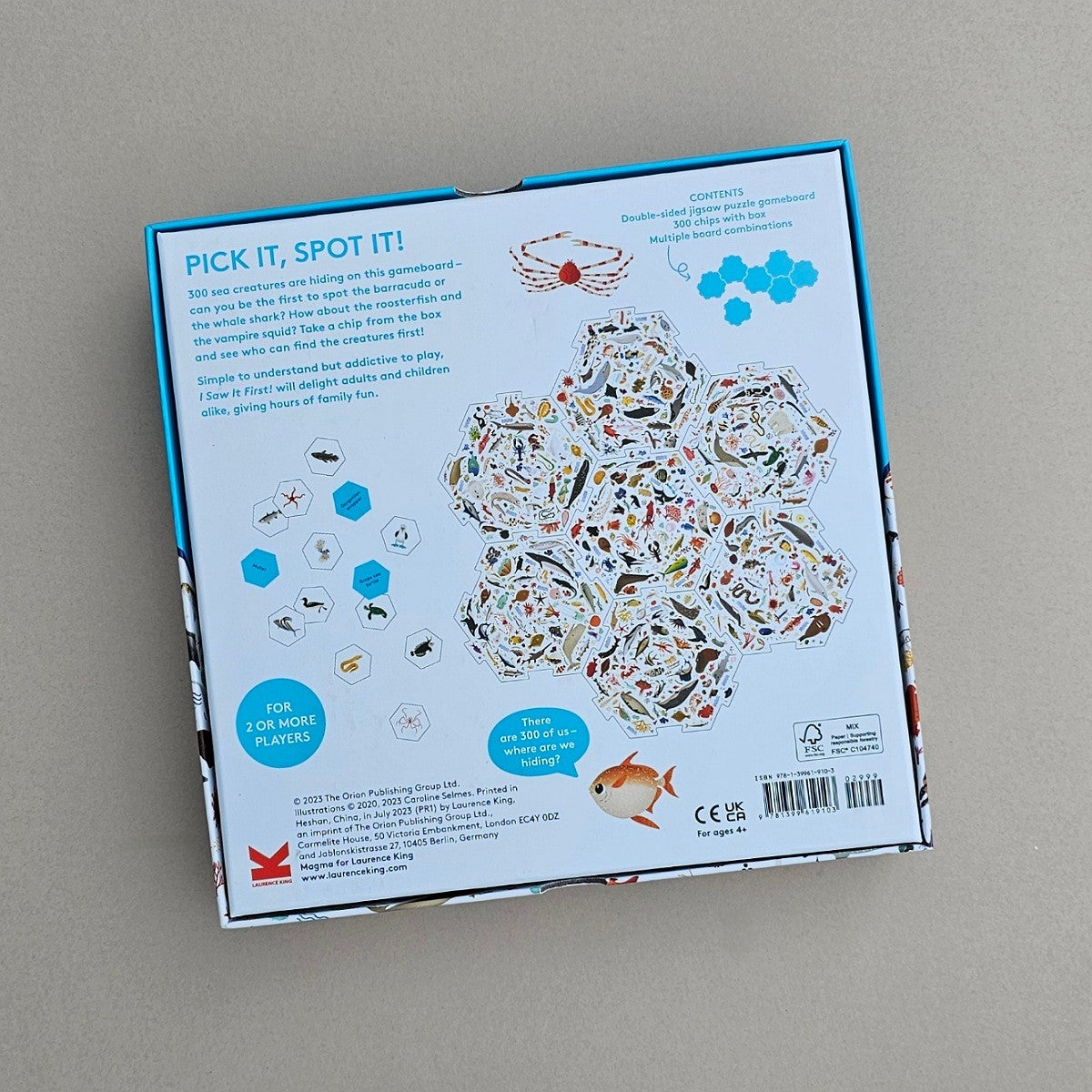 Back of a children's educational game box with illustrations and text on a grey background