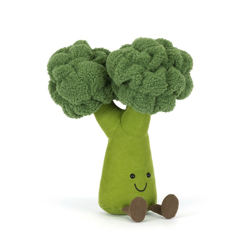 Plush green toy shaped like a broccoli with brown legs and smiley face on a white background