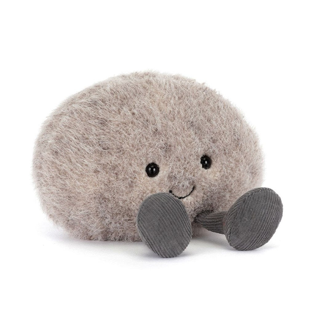 Plush toy resembling a round light grey pebble or stone with dark grey legs with a smiling face on a white background