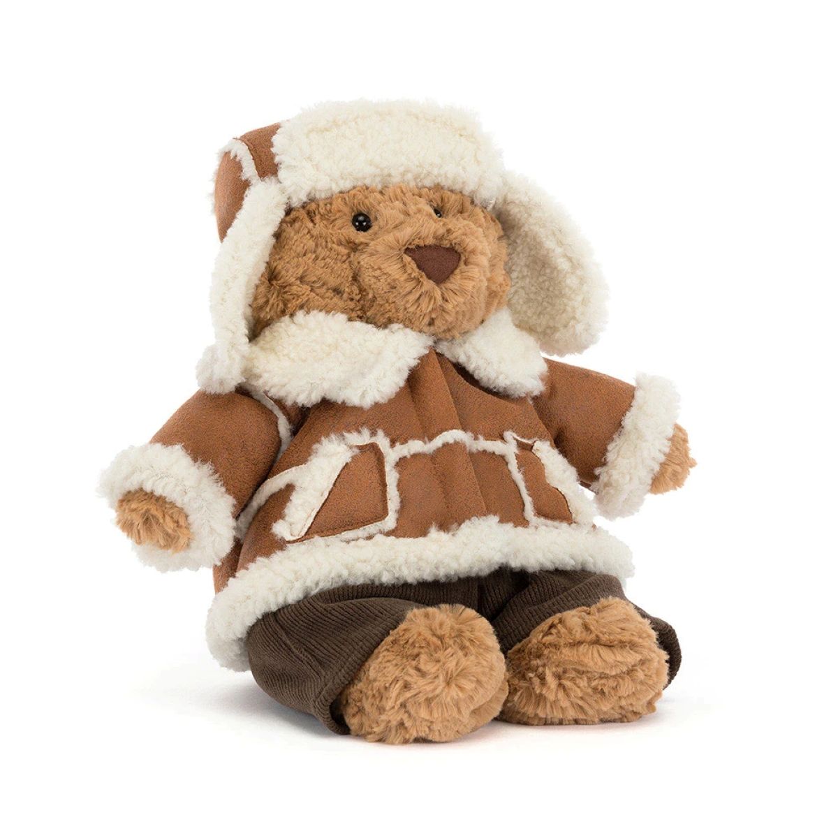 A plush teddy bear wearing a brown and cream winter parka with a matching cream fur-trimmed hat, seated against a plain white background.