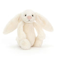 Cream-colored bunny plush toy on a white background