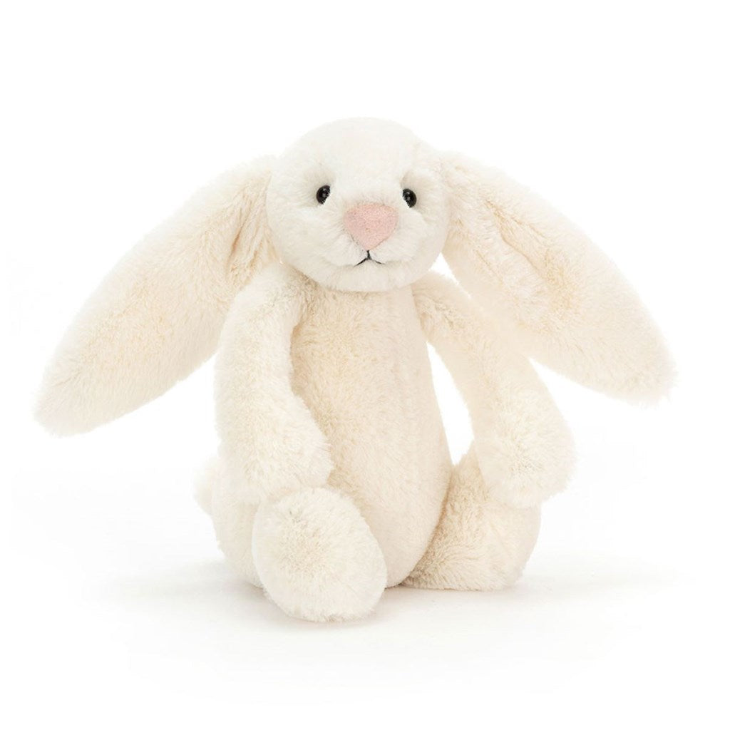 Cream-colored bunny plush toy on a white background