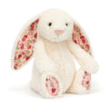 Plush cream bunny toy with strawberry and floral pattern ears on a white background