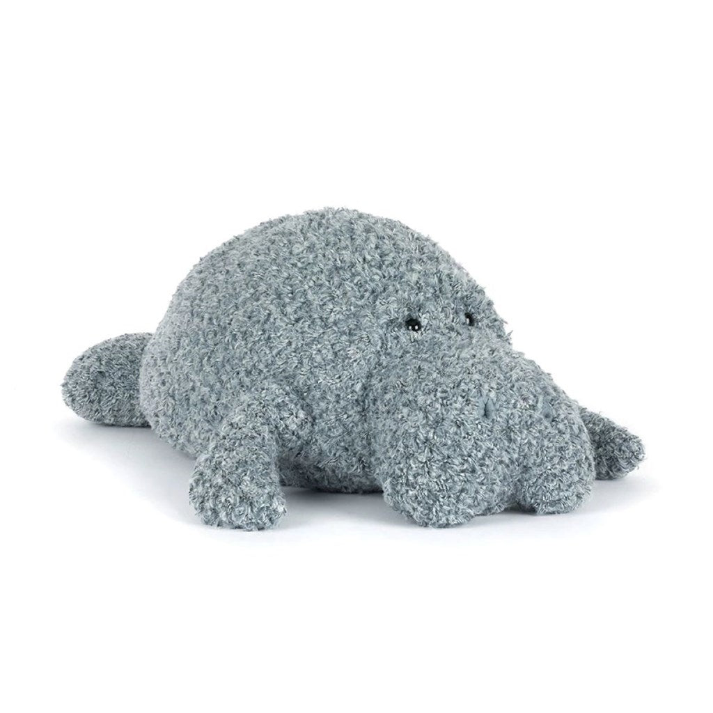 Plush toy grey manatee with textured surface on a white background
