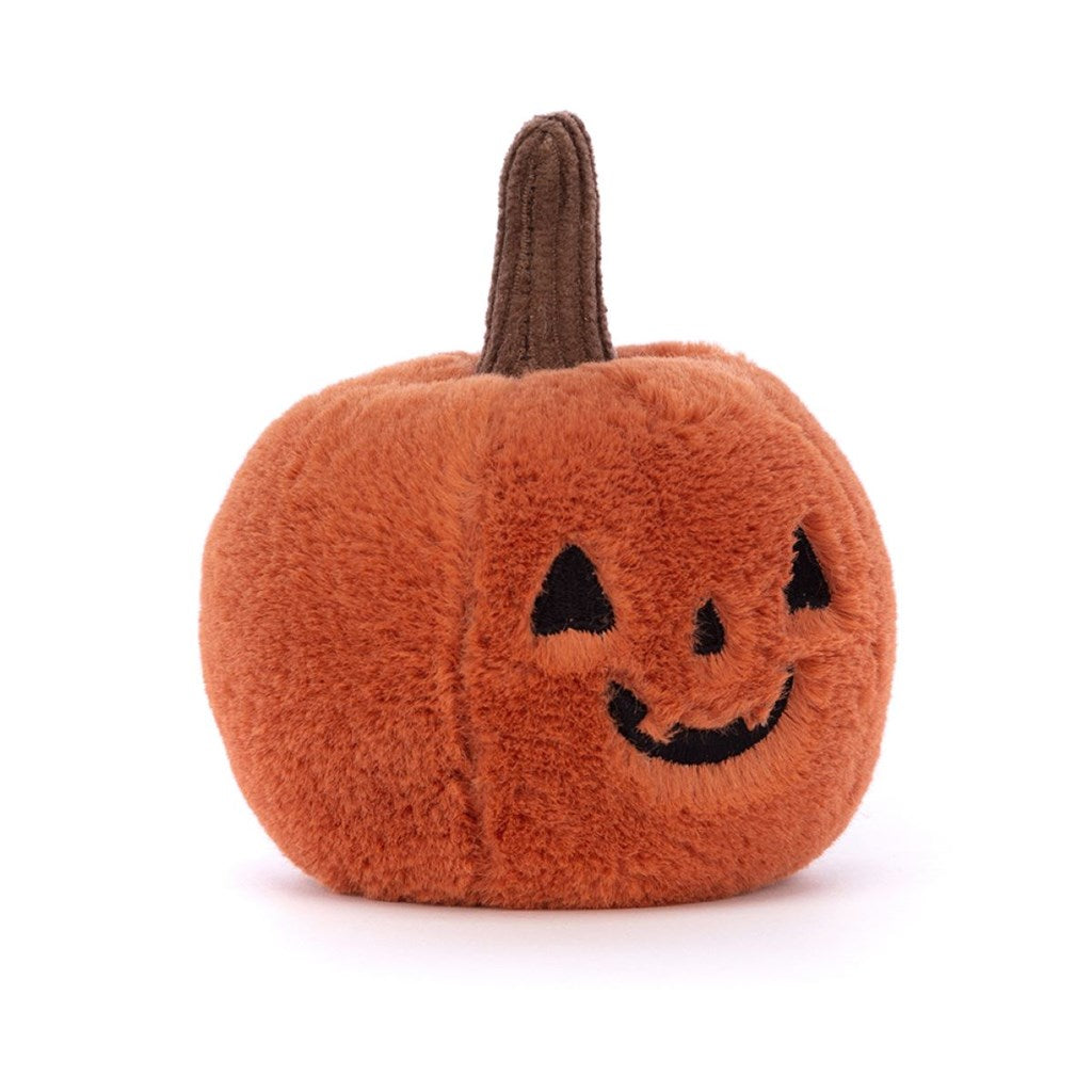 Plush pumpkin toy with a smiling face on a white background