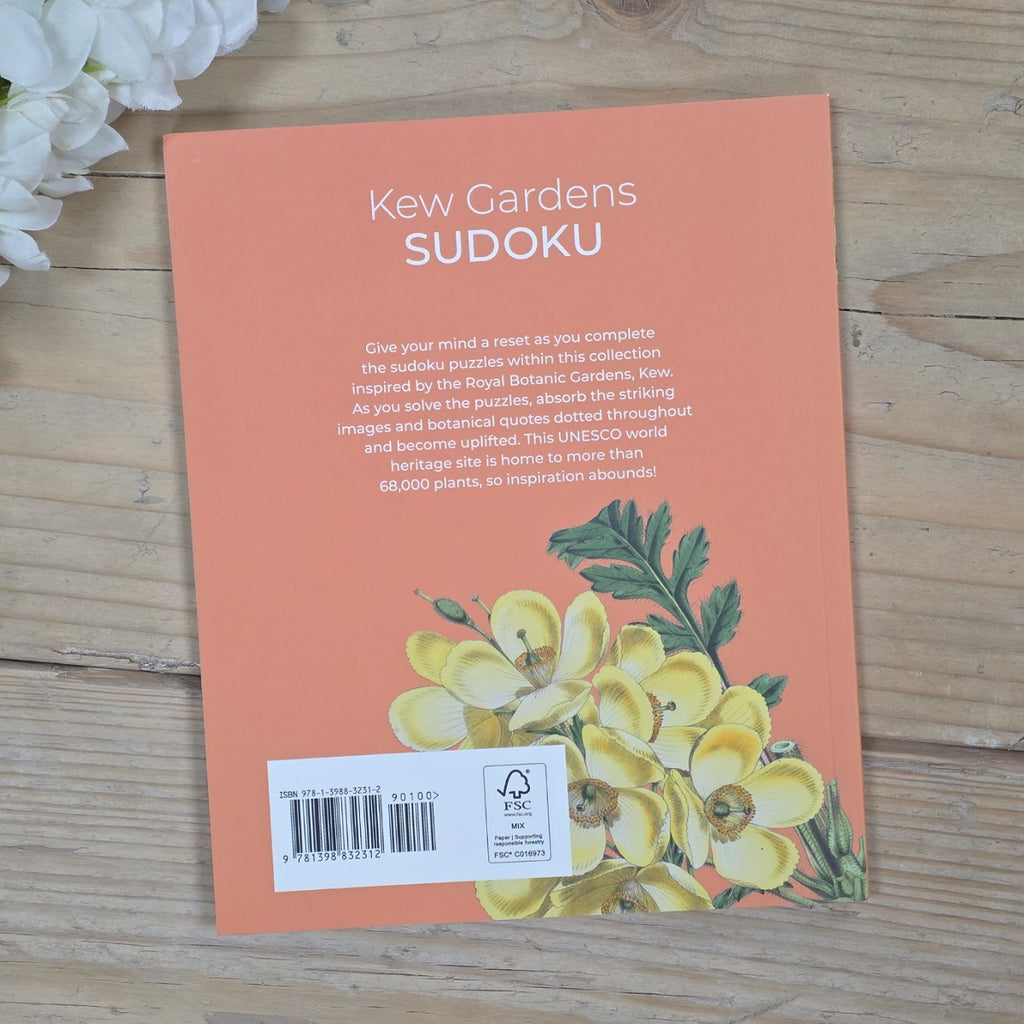 Kew Gardens Sudoku book cover with floral design on a wooden surface