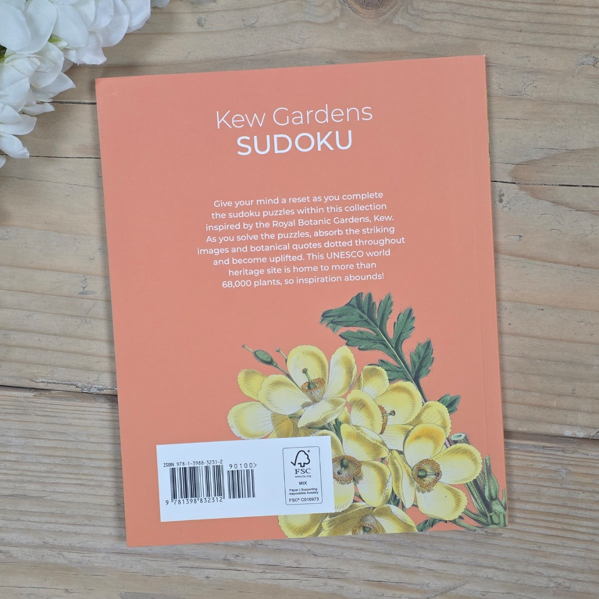 Kew Gardens Sudoku book cover with floral design on a wooden surface