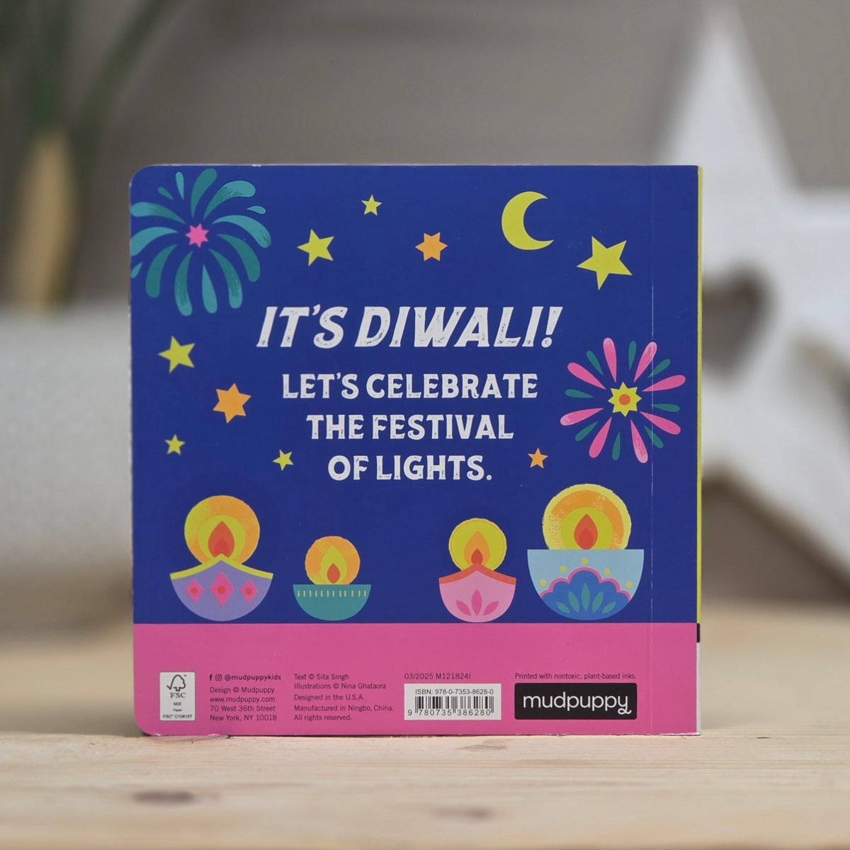 Diwali-themed book with colorful illustrations and text on a wooden surface