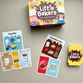 Children's card game 'Little Bakers' with recipe and ingredients cards and packaging on a neutral background