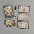 Lost Treasure logic puzzle box with instructions, cards and an errasable pen on a grey background