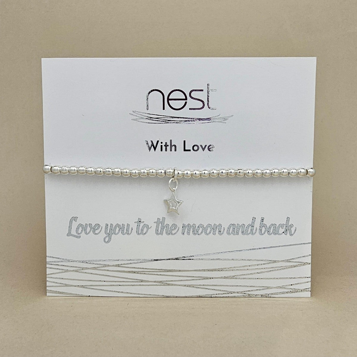 A silver beaded bracelet with a small star charm, presented on a white card from the brand 'nest' that reads 'With Love' and 'Love you to the moon and back'.