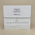 A silver beaded bracelet with a small heart charm, displayed on a white card from the brand 'nest' that reads 'With Love' and 'Love you to the moon and back'.
