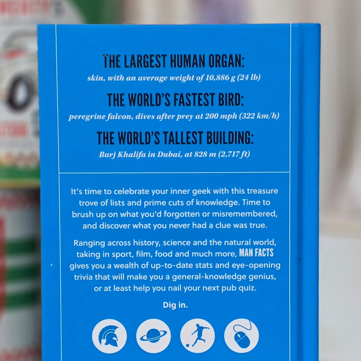 Blue back book cover with text about human organs, fastest bird, tallest building