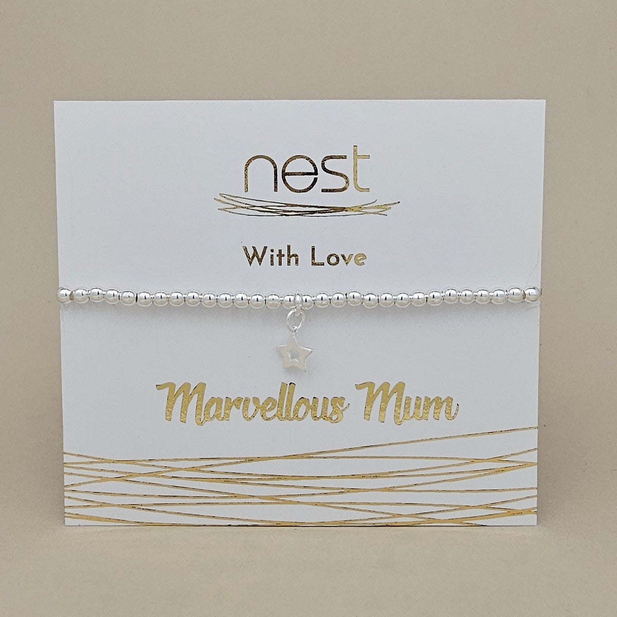 A silver beaded bracelet with a small star charm, presented on a white card with gold foil text that reads 'nest With Love Marvellous Mum'.