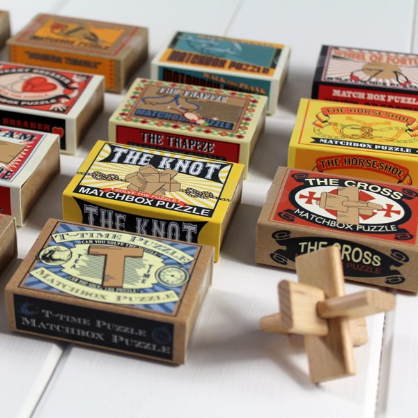 Collection of matchbox puzzles with colorful packaging on a white surface