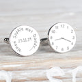 A pair of round silver cufflinks one styled like a clock with a time, the other engraved with 'When Sophie met Daddy 25.11.19'.