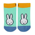 A pair of low-cut socks featuring a pixelated white Miffy bunny face on a mint green background, with a mustard yellow cuff and a blue toe and heel, shown against a plain white background.