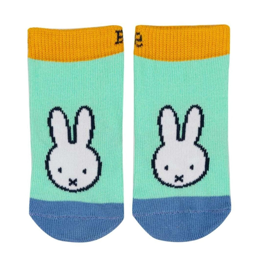 A pair of low-cut ankle socks featuring a pixelated white bunny face on a mint green background, with a mustard yellow cuff and a blue toe, shown on a plain white background.