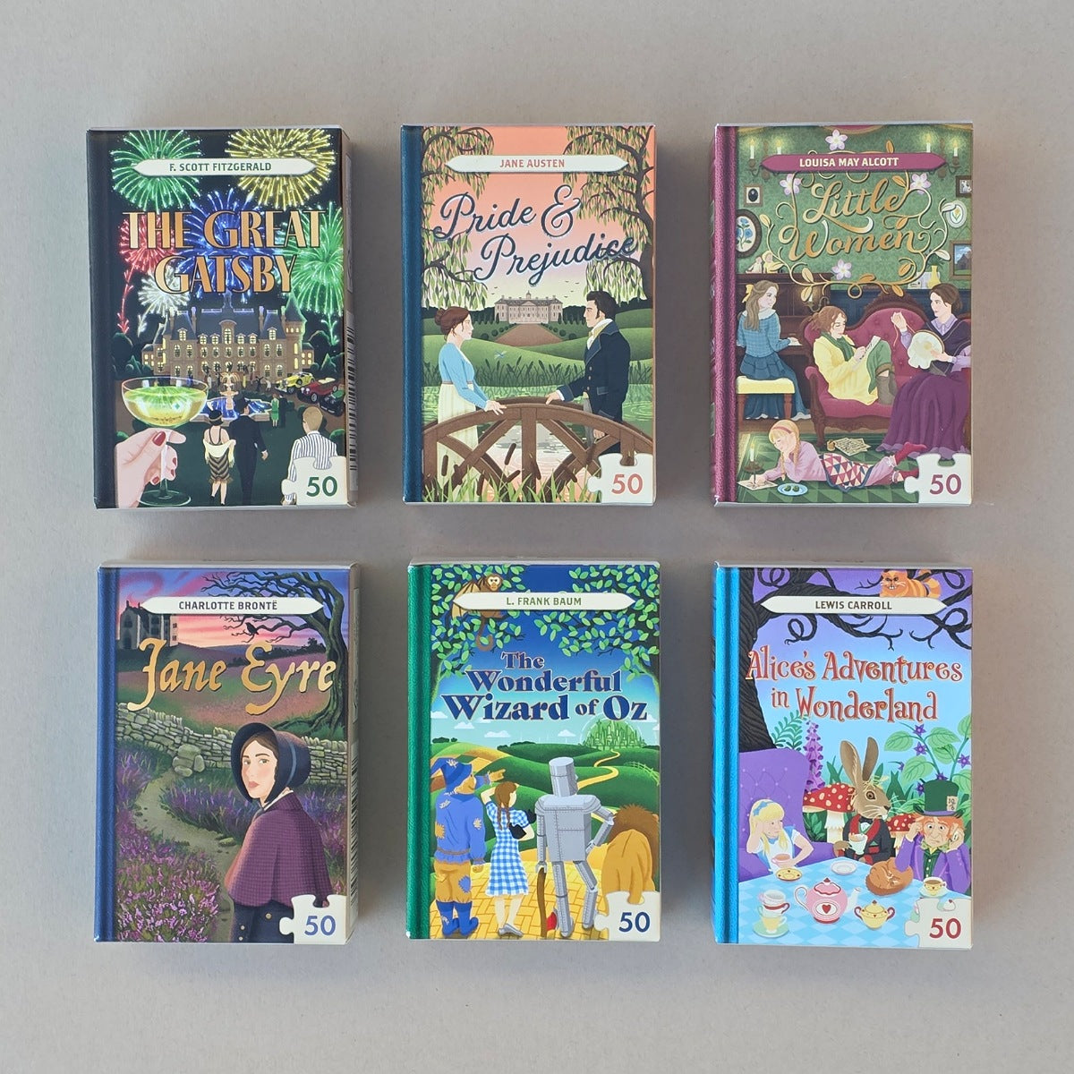 Collection of jigsaw puzzle boxes of classic literature books with colorful covers on a grey background